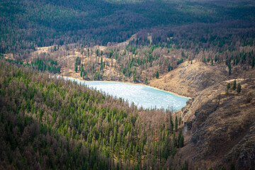 Fototapeta na wymiar Aerial view of large frozen lake in the spring mountains of Altai, Russia
