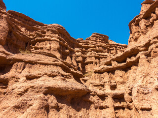 Red tales from clay. Issyk-Kul region in Kyrgyzstan. Beautiful mountain landscape. Tourism and...