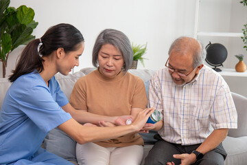 A nurse give a medicine to senior at retired home service.