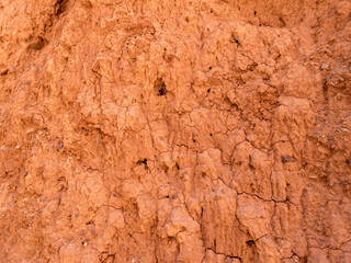 Texture of red clay. Natural natural patterns. Dry red background closeup.