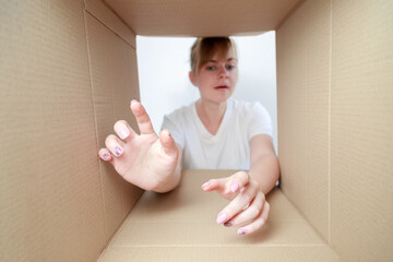 the woman looks into the delivery box. fan