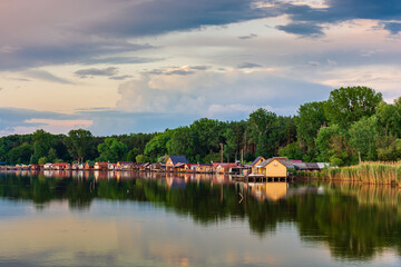 Fototapeta na wymiar Floating village on Bokod lake in Hungary, dramatic sunset sky