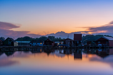 Floating village on Bokod lake in Hungary, dramatic sunset sky
