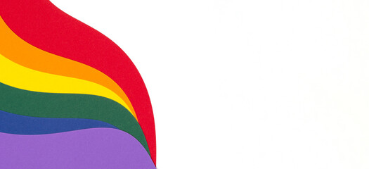 Lgbtq colors flag paper composition on white background. Rainbow colors layout background. Pride community. Top view