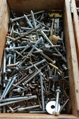 A lot of the gray screws in a box