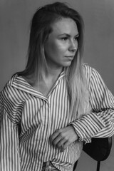 Young girl in casual relaxed pose at home. Young blonde emotional sensual woman in jeans