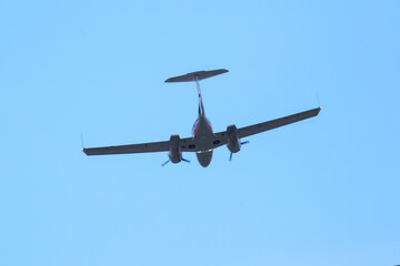 twin-engine light aircraft flying in the sky