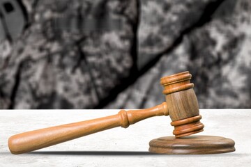 Military Law concept, soldier and wooden gavel at courtroom.