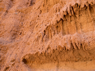 Texture of red clay. Natural natural patterns. Dry red background closeup.
