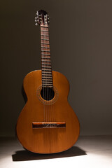 Classical guitar on a light wood floor with copy space