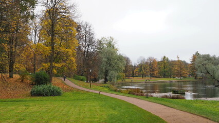 Autumn landscape in the park, trees, ponds and paths. Gatchina Palace Park. City of Gatchina, Russia.