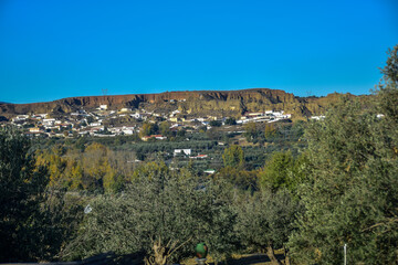 Obraz premium Guadix, Spain - 09 november 2019: View from the hill to Guadix, is famous for its cave houses. These cave houses are up in the hills and are in the Troglodyte Quarter (Barrio Troglodyte) of the city