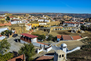 Guadix, Spain - 09 november 2019: View from the hill to Guadix, is famous for its cave houses. These cave houses are up in the hills and are in the Troglodyte Quarter (Barrio Troglodyte) of the city