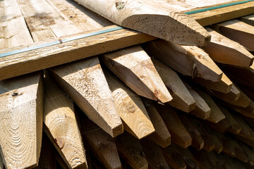 Abstract view of newly sawn fence posts seen awaiting to be despatched to construction companies.  The sharpened ends are used to be struck into soft ground.