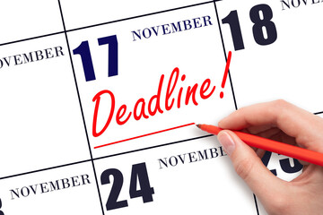 Hand drawing red line and writing the text Deadline on calendar date November 17. Deadline word written on calendar