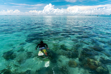 Unidentified person snorkeling in a blue sea in Celebes sea Semporna Sabah Borneo Malaysia