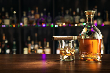 close up view of cigar, bottle of whiskey and  glass aside on color back.  - 509217938
