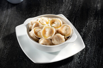 close up view of plate with dumplings  on grery background.