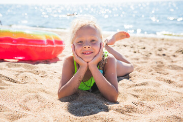 Portrait of little girl with inflatable rubber circle on beach