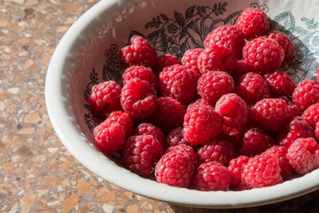 Raspberries in a plate. The collected berries of a raspberry