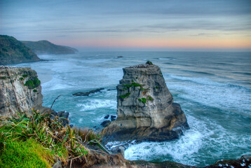 Fototapeta na wymiar Sunset of the Gannet Rock at Murwai Beach, West Coast, Auckland, New Zealand