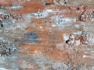 Abstract beautiful colored traces formed on the dirt road after heavy braking of the car.