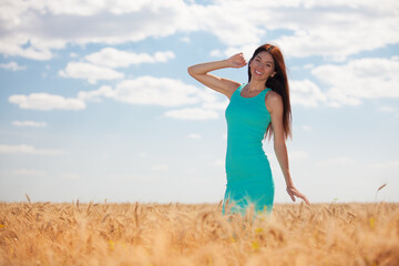 Happy woman enjoying the life in the field. Nature beauty, blue sky, white clouds and field with golden wheat. Outdoor lifestyle. Freedom concept. Woman walk in summer field - 509219362