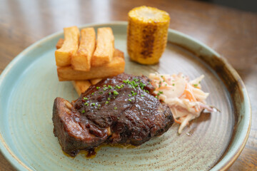 Tender steak meat meal served with chunky chips, coleslaw and corn on the cob.