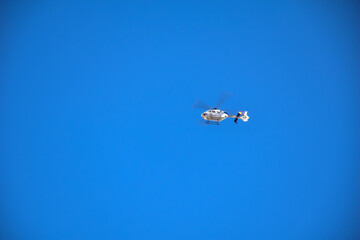 Madrid, Spain - 03 november 2019: The helicopter is flying against the blue sky