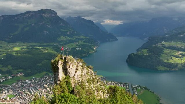 Lake Lucerne aerial view, epic beautiful view of mountain lake in Switzerland with Swiss flag on a rock, panoramic view of Luzern lake, amazing Swiss alpine landscape 