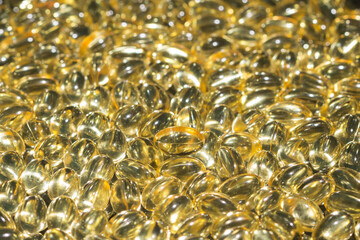 Fish oil capsules spilled to make a background