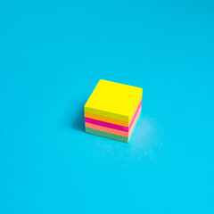 cube with note paper multicolored on a blue background