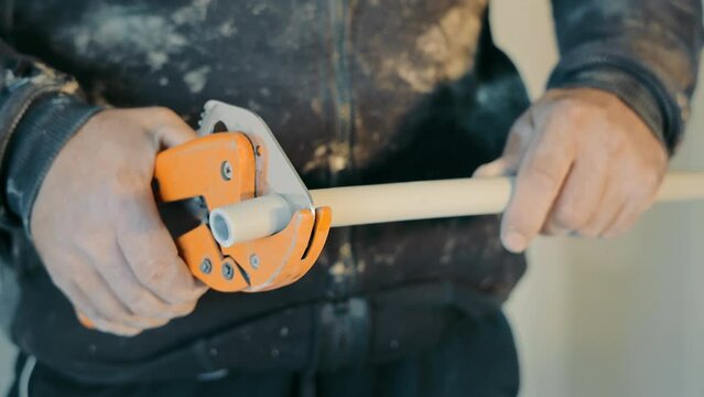 Close-up of a plumber cuts a caesarean section with a specialized cutter and scissors.
