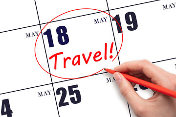 Hand drawing a red circle and writing the text TRAVEL on the calendar date 18 May. Travel planning.