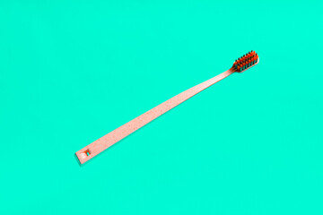 Floating eco toothbrush on mint green background,  close up