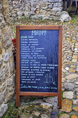 A menu board near a street cafe in the ancient town. The Way of St. James, Northern Route, Spain