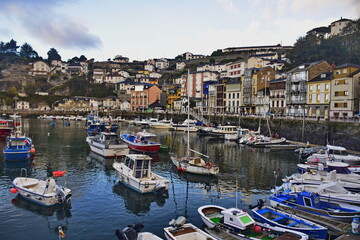 Fototapeta na wymiar Colorful fishing boats anchored near the port. The Way of St. James, Northern Route, Spain