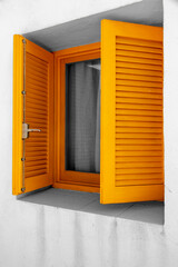 window with yellow shutters