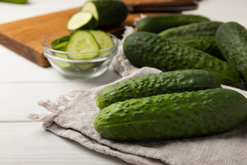 Fresh organic cucumbers whole and slices on wooden texture background.Ingredient for salad.Fresh vegetables.Vegan food.Healthy food.Fresh organic vegetable.Copy space.