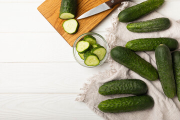 Fresh organic cucumbers whole and slices on wooden texture background.Ingredient for salad.Fresh vegetables.Vegan food.Healthy food.Fresh organic vegetable.Copy space.