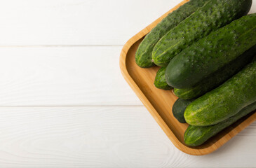 Fresh organic cucumbers whole and slices on wooden texture background.Ingredient for salad.Fresh vegetables.Vegan food.Healthy food.Fresh organic vegetable.Copy space.