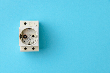 Old electrical socket with traces of fire due to a short electrical circuit.