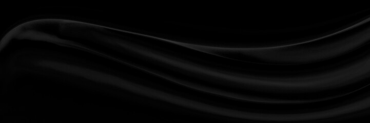 Black gray satin dark fabric texture luxurious shiny that is abstract silk cloth panorama background with patterns soft waves blur beautiful.