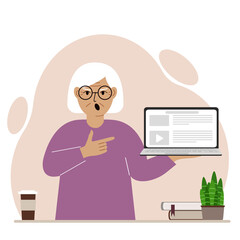 Screaming grandmother holding a laptop computer with one hand and pointing at it with the other. Laptop computer technology concept.