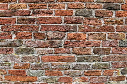 Fototapeta Wall of ancient red and grey bricks. Detail of the medieval brick wall of an old church in the north of the Netherlands 
