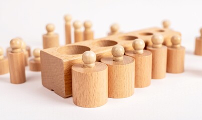 Montessori knobbed wooden cylinders with block. Kids puzzle for comparison, grading and seriation development. High quality photo