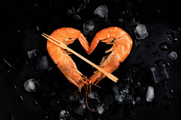 Cooked shrimps,prawns heart shape  on stone background with ice.Top view.Valentine's Day celebration.