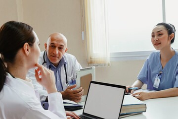 Team doctor, nurse and internship doctor talking and discussing about surgery treatment patient’s case while sitting in the meeting room office in hospital. healthcare and medical concept.