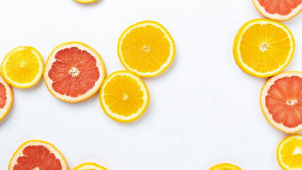 Fototapeta na wymiar Fruity summer citrus background. Oranges, grapefruit and kiwi sliced on a white background