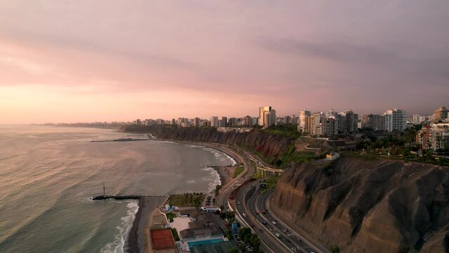 Aerial view along Lima, Peru along the coast also known as Circuito de Playas de la Costa Verde at a golden hour sunset